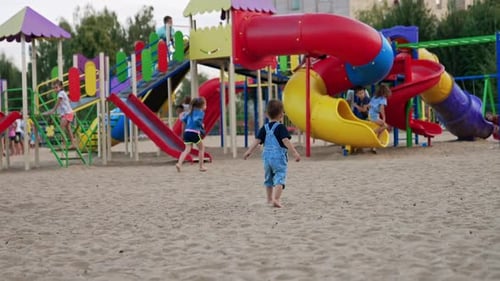 Child on colorful kindergarten. Small boy playing on playground.