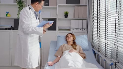 Doctor Visits Young Woman in Hospital Room