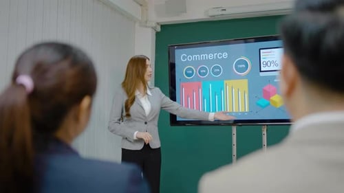 Woman Giving Business Presentation With Commerce Data