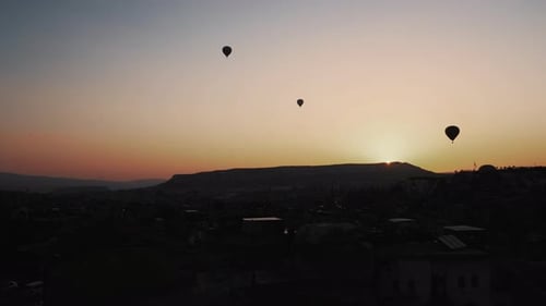 Sunrise over Ancient City with Hot Air Balloons