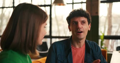 Expressive Handsome Man Talking with Beautiful Woman in Cafe Communication Concept