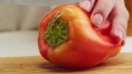 Cutting an Orange Bell Pepper With Knife
