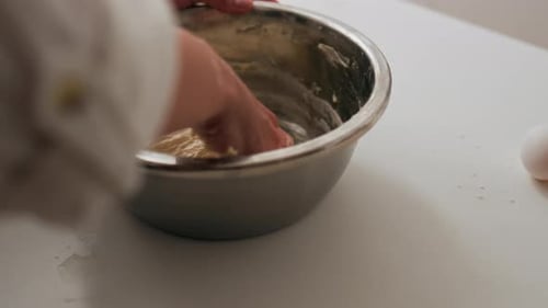 Der Vorgang des Knetens des Teigs zum Backen, Der Koch knetet den Teig mit seinen Händen, Zubereiten