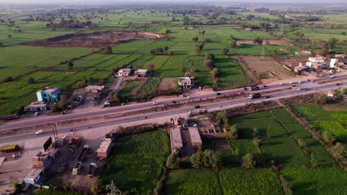 Crop fields lands with national highway and vehicles at Harnampur, madhya pradesh, india. day time,