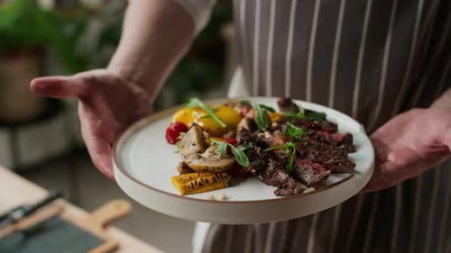 Chef Presenting Grilled Steak with Vegetables