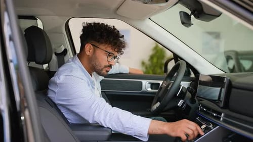 Customer Exploring New Car Features in Dealership Showroom