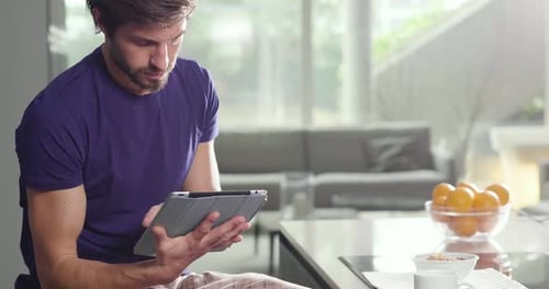 Man Using Tablet at Table Indoors