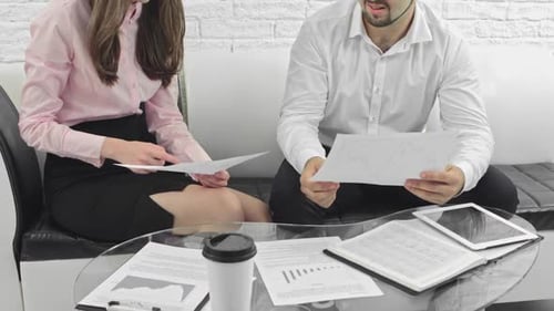 Business Meeting Between Two People with Documents