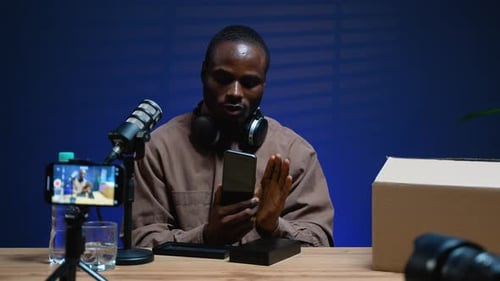 Adult reviews new phone for video blog