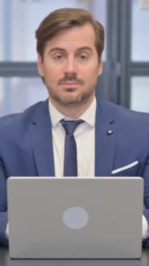 Man Working on Laptop in Modern Office