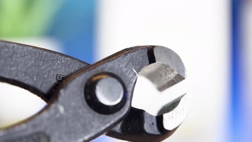 Close-up of end cutting pliers in use, showcasing their sharp precision and durable design.