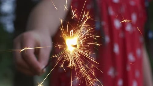 Child's Hand Holding Sparkling Sparkler Celebration