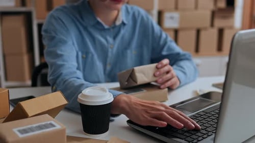 Productivity, Warehouse Worker Joyfully Works At A Laptop In A Packaging Warehouse, In Slow Motion