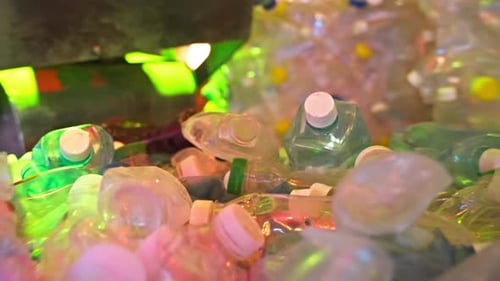 Many Plastic Bottles on Recycling Plant Crushing Process in Recycling Machine