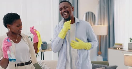 Happy Couple Cleaning and Dancing at Home