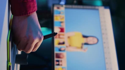 Graphic Designer Using Stylus Editing Photos on Monitor