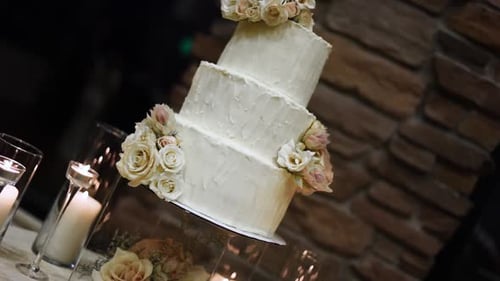 Elegant Three Tier Wedding Cake With Decorated With Flowers. - close up