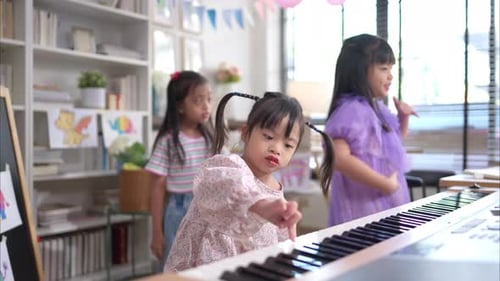Children Playing Music and Dancing Together in Classroom