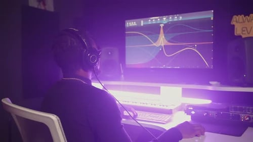 African American Man is Sound Designer Working in Modern Music Recording Studio Processing Records