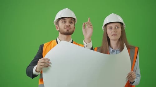 Male and Female Civil Engineers Holding Blueprint and Discussing Project