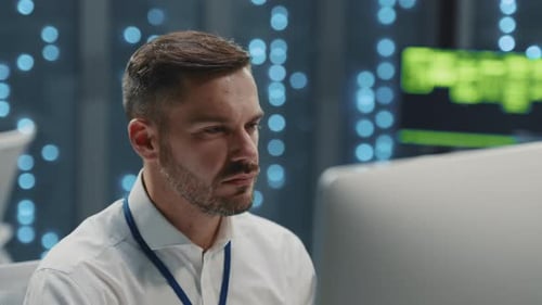 Bearded IT Specialist Programming Code Developing Software in Technological Server Room Data Center