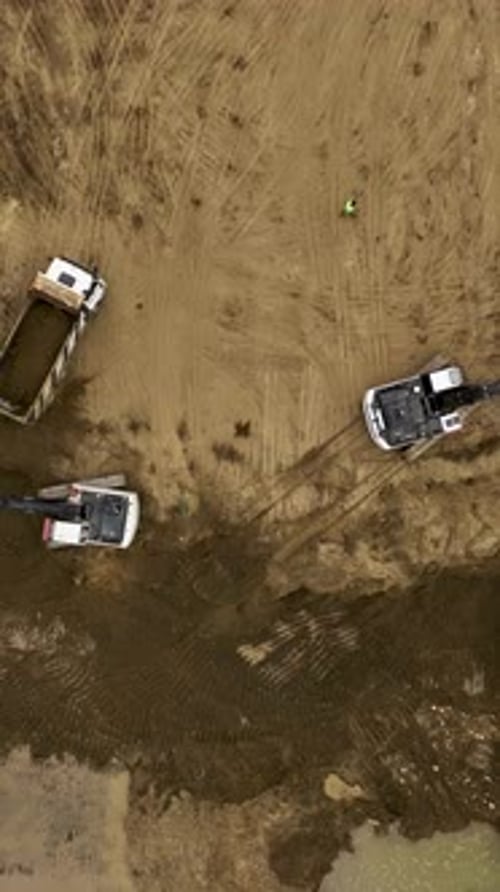 Aerial View of Excavators and Dump Trucks