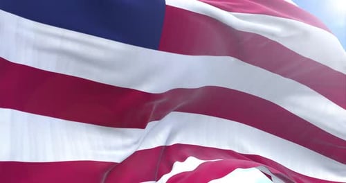 Realistic Liberia Flag Waving in Wind Against Sunny Blue Sky