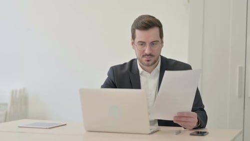 Man Celebrates Business Success in Office