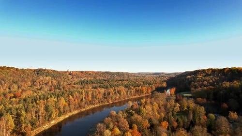 Scenic autumn view of a winding river surrounded by colorful trees