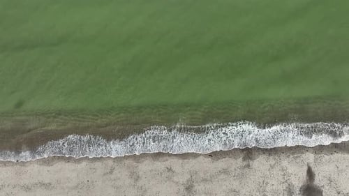 Top view of Sandy Neck Beach with continuous tides hitting the shore at Cape Cod, Barnstable Massach