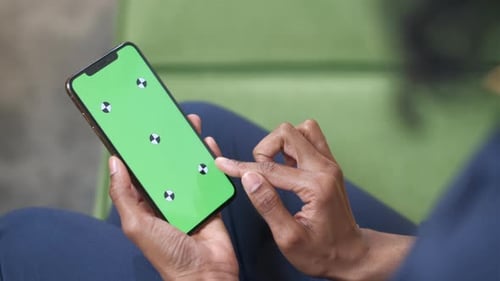 A black woman with a smartphone in her hand. Touch screen gestures on the screen