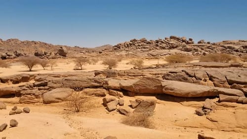 Panning shot of the barren and rugged landscape of the Algerian Sahara Desert near Tamanrasset