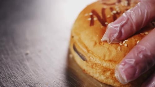Cutting Burger Bun With Knife For Delectable Meal