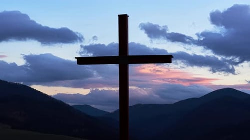 Christian Cross in Mountain Rural Landscape Clouds in Blue Sky at Dusk