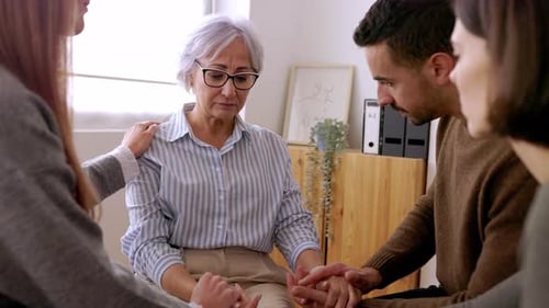 Diverse People Sitting in Circle Receiving Support During a Therapy Session