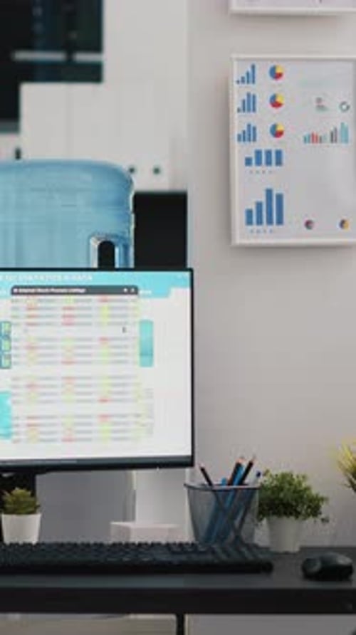Vertical Video Company Workspace with Nobody in and Business Figures on Computer Monitors