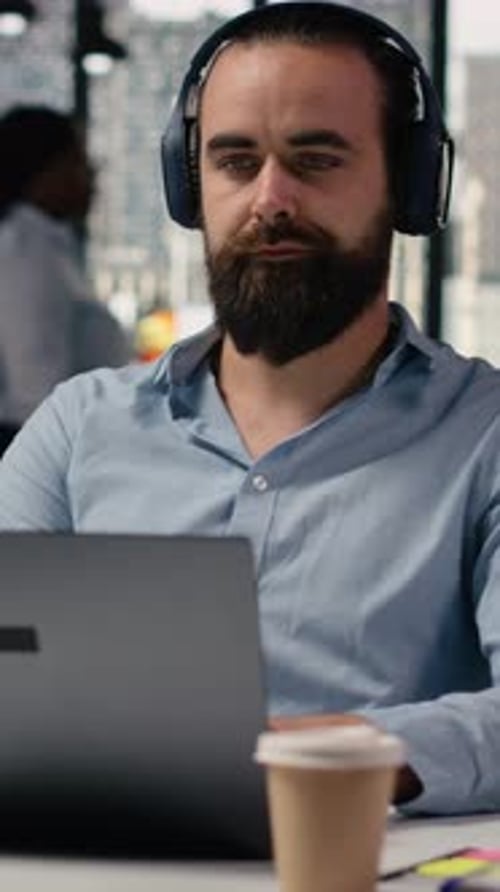 Vertical Video Headphones in Office Working with Focus Music Business Employee at Desk