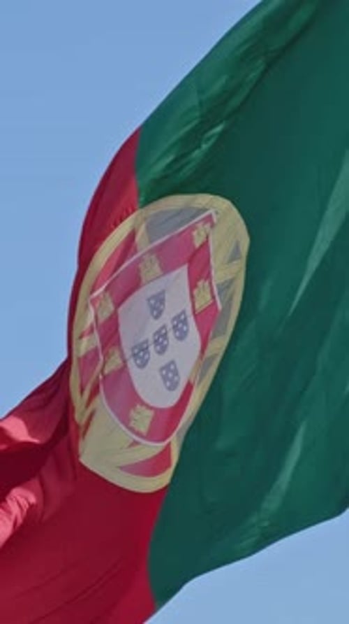 National Flag of Portugal Waving in the Wind on Clear Sunny Day at Blue Sky Real Footage Selective