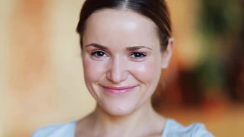 Attractive woman smiles into the camera in close-up