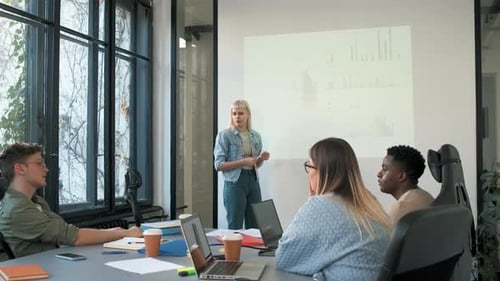 Diverse group of young people working on new project together in office.
