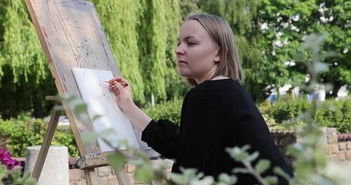 The young woman sketching a floral composition with a pencil