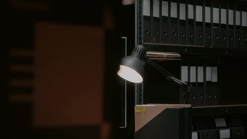 Dimly Lit Office With Files and Desk Lamp
