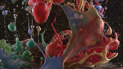 Abstract ink flowing into oil creates a vibrant swirling pattern in slow motion