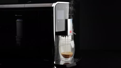 Coffee Machine Dispensing Layered Steamy Coffee into Glass