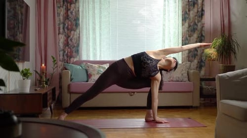 Woman Practicing Yoga in Living Room During Daytime