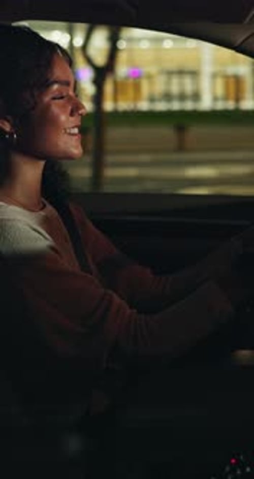 Night, driving and happy woman in car on city street, vehicle navigation