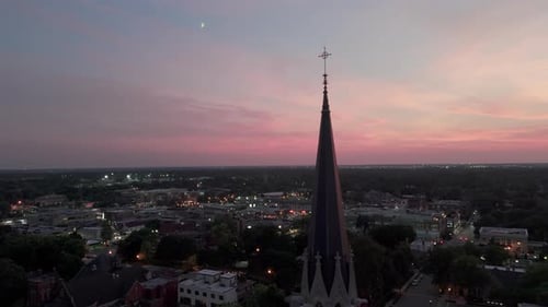 The Silhouette of the Cross and Church Bell Tower in Sunrise Sunset Time Drone Shot