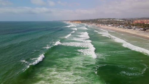 Foamy White Waves Coming To The Sandy Shoreline of Beach In Del Mar, San Diego County, California, U