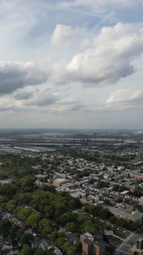 Sweeping aerial footage capturing a sprawling urban area with residential buildings and green