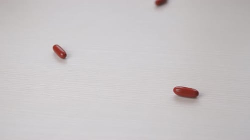Painrelieving Red Pills Fall on the Table